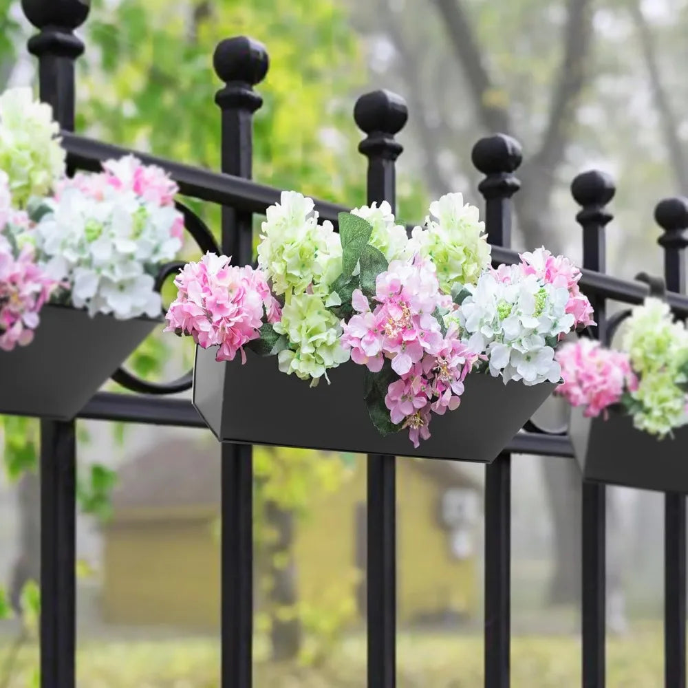 Railing planter box holding blooming flowers on a balcony